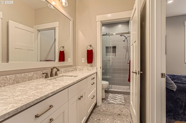 bathroom with a stall shower, toilet, and vanity