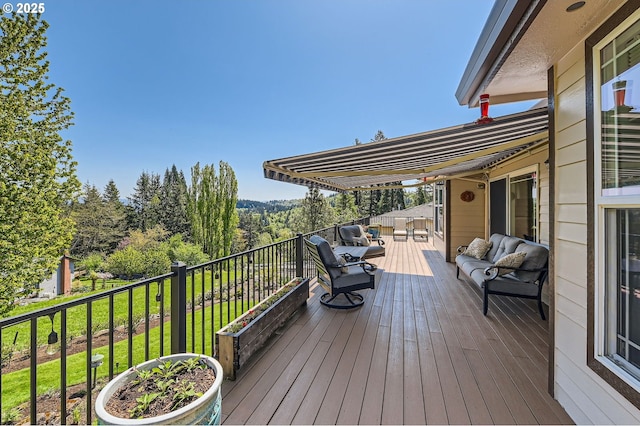 wooden terrace with an outdoor hangout area