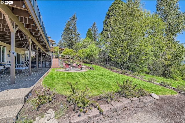 view of yard with stairway, an outdoor fire pit, and a patio area