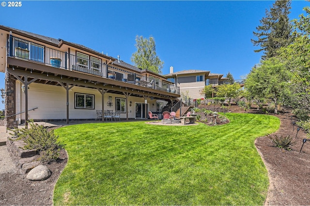 back of property featuring a wooden deck, a patio, stairs, and a lawn