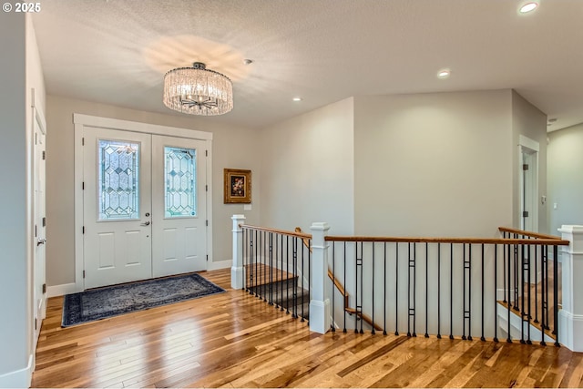 foyer featuring a chandelier, hardwood / wood-style floors, and recessed lighting
