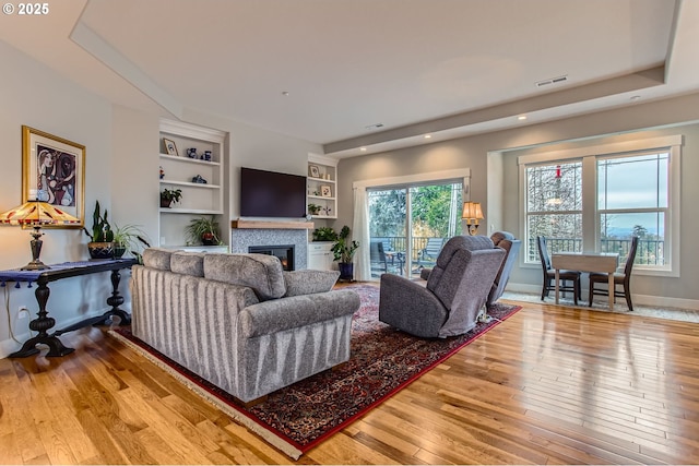 1543 SW Walters Loop, Gresham, OR 97080 - living room with hardwood / wood-style flooring, a glass covered fireplace, recessed lighting, built in features, and baseboards