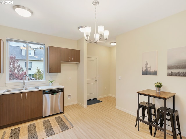 kitchen with sink, light hardwood / wood-style flooring, dishwasher, a notable chandelier, and pendant lighting