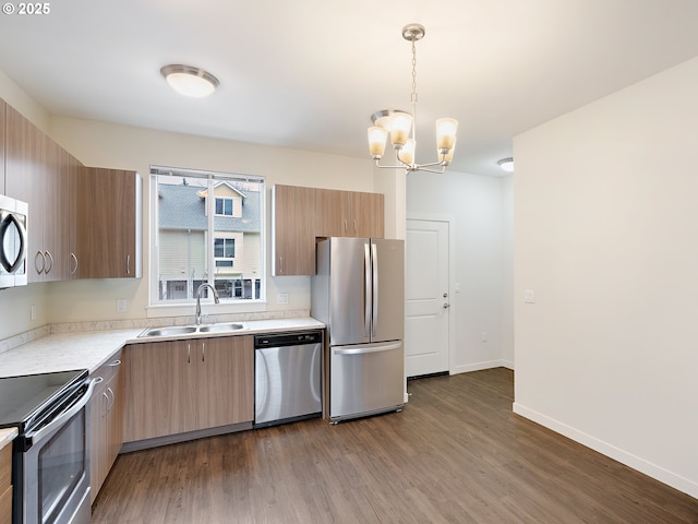 10829 E Burnside St, Portland, OR 97216 - kitchen with stainless steel appliances, a sink, dark wood-style floors, light countertops, and a chandelier