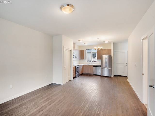 10829 E Burnside St, Portland, OR 97216 - kitchen featuring appliances with stainless steel finishes, a chandelier, light countertops, and dark wood finished floors
