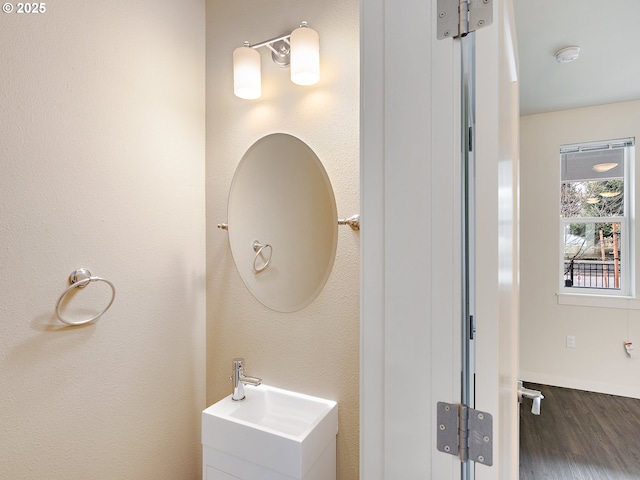 10829 E Burnside St, Portland, OR 97216 - bathroom featuring wood finished floors, vanity, and baseboards