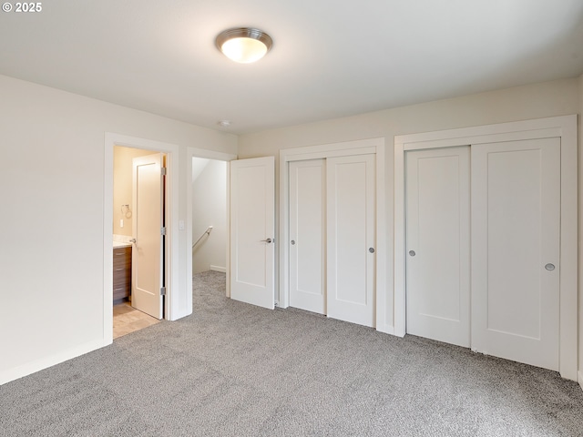 10829 E Burnside St, Portland, OR 97216 - unfurnished bedroom featuring multiple closets, carpet, and connected bathroom