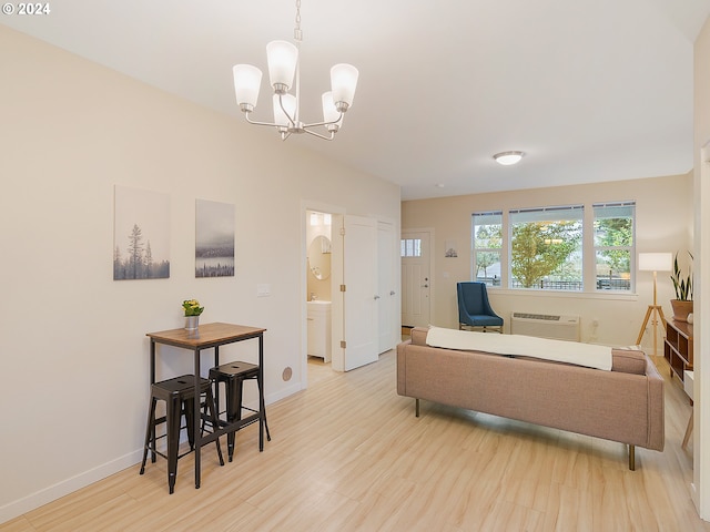 living room with a chandelier, a wall mounted AC, and light hardwood / wood-style floors