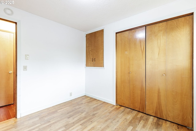 7430 N Burr Ave, Portland, OR 97203 - unfurnished bedroom with light wood finished floors, a closet, and baseboards