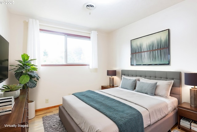 7430 N Burr Ave, Portland, OR 97203 - bedroom with light wood-style flooring, multiple windows, and baseboards