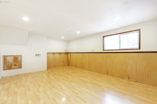 7430 N Burr Ave, Portland, OR 97203 - empty room with wood finished floors, recessed lighting, and wainscoting