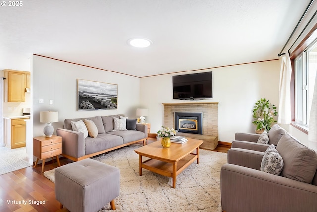7430 N Burr Ave, Portland, OR 97203 - living area featuring wood finished floors, a glass covered fireplace, and crown molding