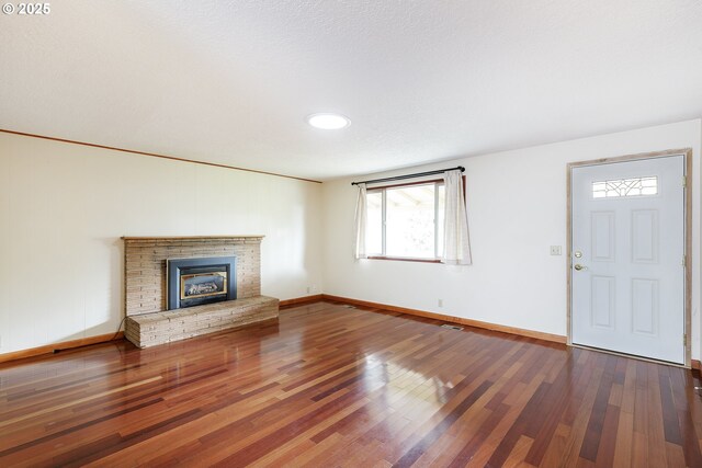 7430 N Burr Ave, Portland, OR 97203 - unfurnished living room with wood finished floors, baseboards, and a fireplace