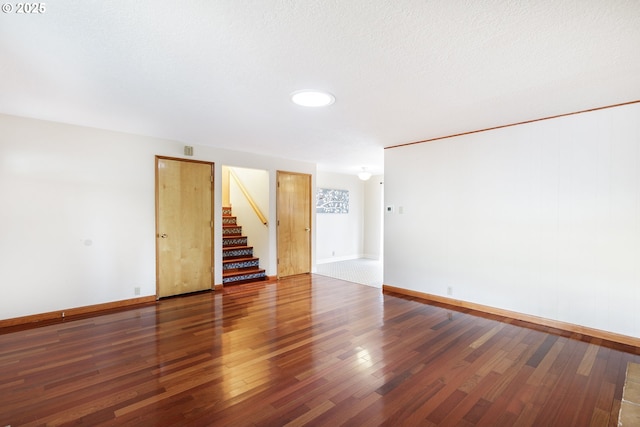 7430 N Burr Ave, Portland, OR 97203 - empty room with wood finished floors, stairway, and baseboards