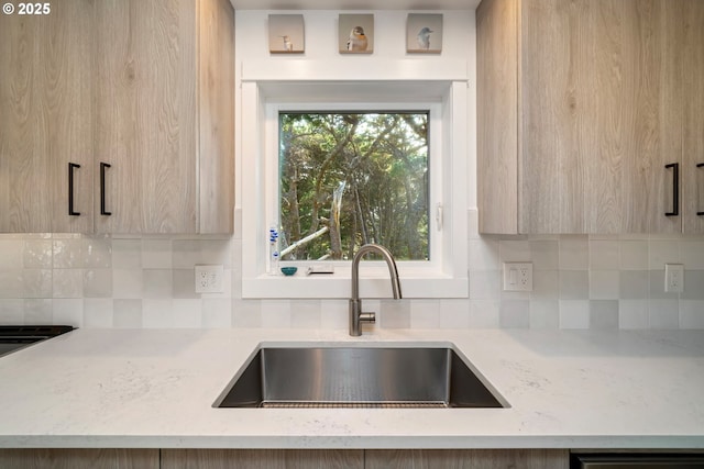 90 Beach Dr, Manzanita, OR 97130 - kitchen with modern cabinets, backsplash, light stone countertops, and light brown cabinets