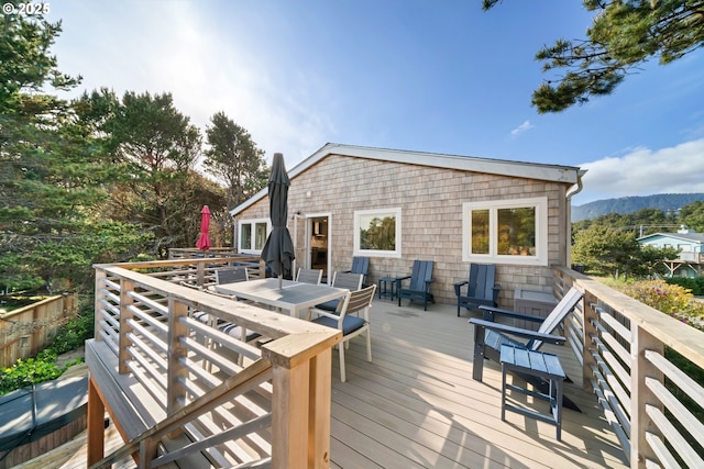 90 Beach Dr, Manzanita, OR 97130 - wooden deck with outdoor dining space and a mountain view