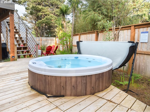90 Beach Dr, Manzanita, OR 97130 - deck with a hot tub, a fenced backyard, and stairs