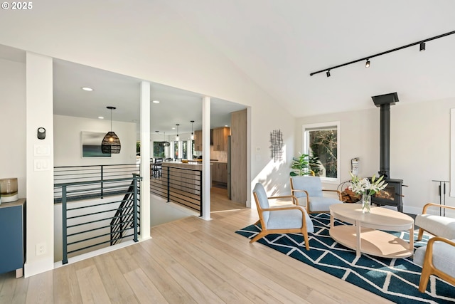90 Beach Dr, Manzanita, OR 97130 - dining area featuring a wood stove, light wood-type flooring, vaulted ceiling, and recessed lighting