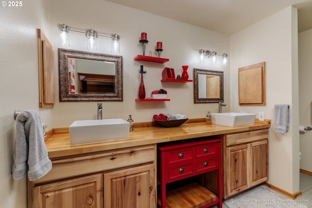 bathroom with tile patterned floors, vanity, and toilet