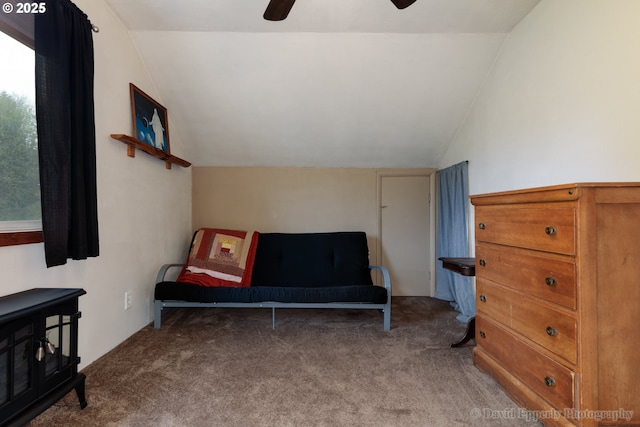 sitting room with ceiling fan, carpet floors, and lofted ceiling