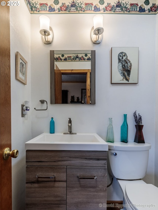 bathroom with toilet and vanity