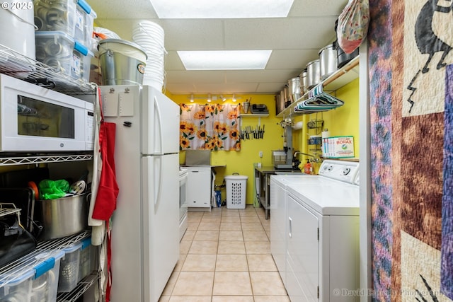 laundry room with light tile patterned floors and washing machine and dryer