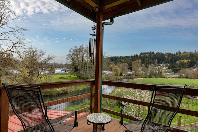 wooden terrace featuring a water view