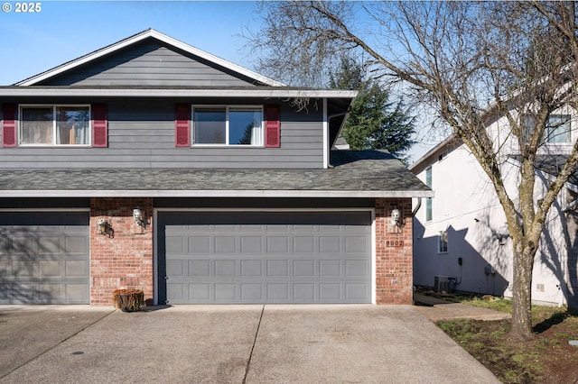 view of front of house featuring central AC and a garage