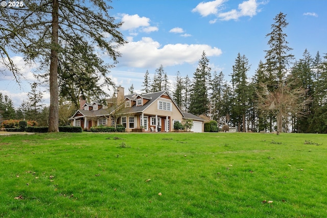 view of front of house featuring a garage, a front lawn, and a chimney