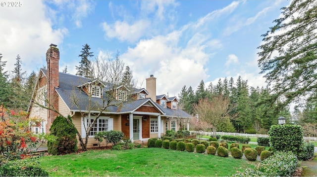 view of front of house with a shingled roof, crawl space, a chimney, and a front lawn