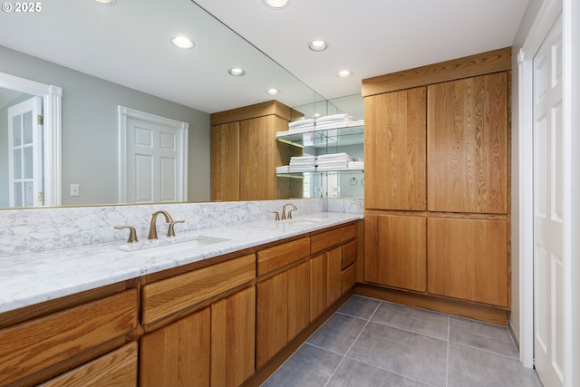 full bath featuring double vanity, tile patterned flooring, a sink, and recessed lighting