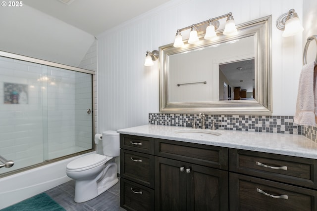 bathroom featuring bath / shower combo with glass door, toilet, decorative backsplash, vaulted ceiling, and vanity