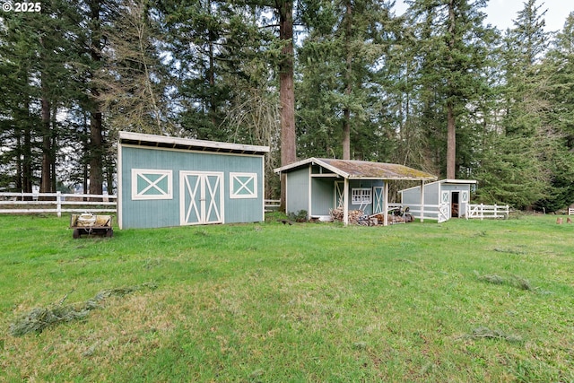 view of outbuilding with an outdoor structure and fence