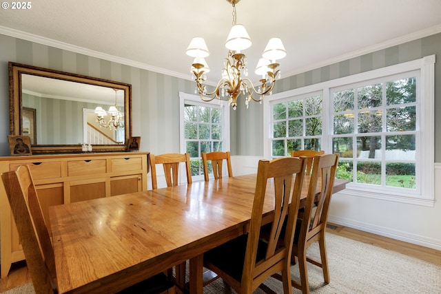 dining space with a chandelier, crown molding, baseboards, and wallpapered walls