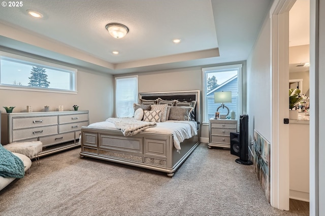 carpeted bedroom with recessed lighting and a textured ceiling