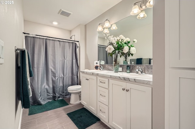 bathroom featuring a sink, visible vents, curtained shower, and double vanity