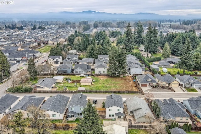 birds eye view of property with a mountain view and a residential view