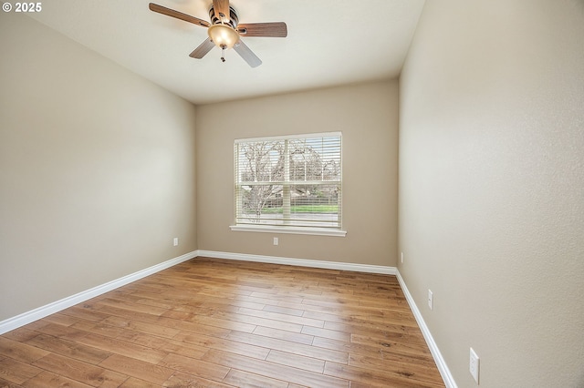 unfurnished room featuring baseboards, wood finished floors, and a ceiling fan