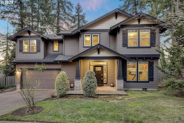 craftsman inspired home with a yard and a garage