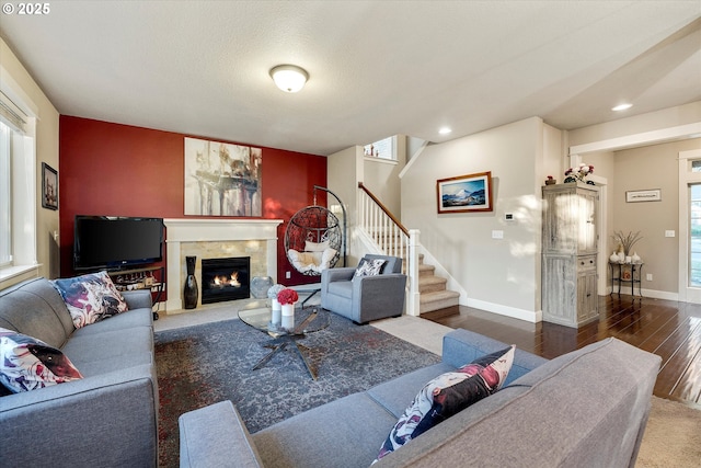 living room with dark hardwood / wood-style flooring, a wealth of natural light, and a textured ceiling