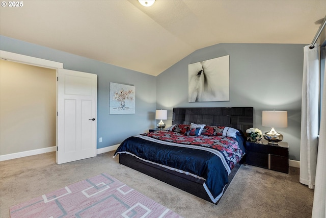 bedroom featuring lofted ceiling and carpet