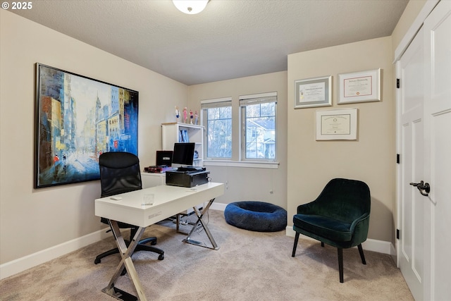 office space with light carpet and a textured ceiling