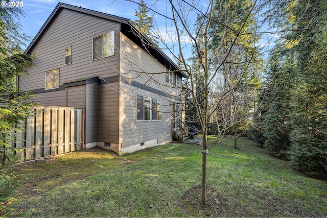 view of side of home with a yard