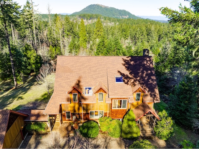 bird's eye view featuring a mountain view and a wooded view