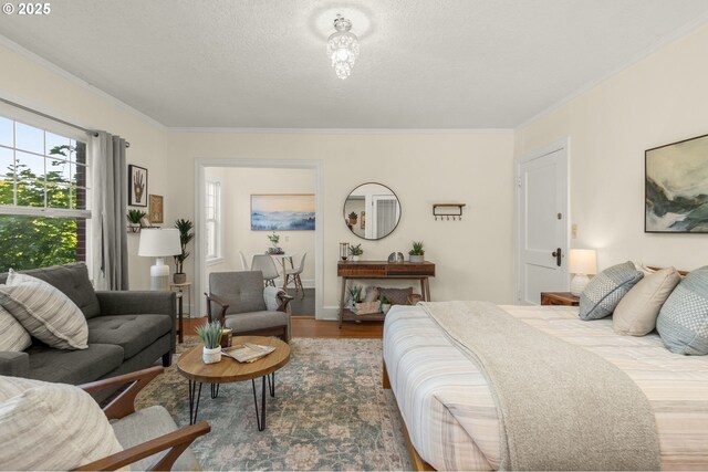 bedroom featuring ornamental molding and wood finished floors
