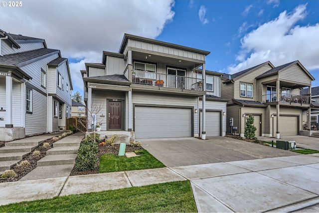 townhome / multi-family property with a garage, board and batten siding, and concrete driveway