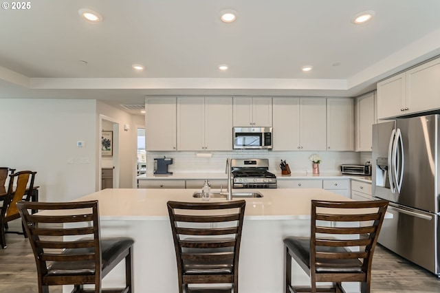 kitchen featuring stainless steel appliances, recessed lighting, light countertops, and decorative backsplash