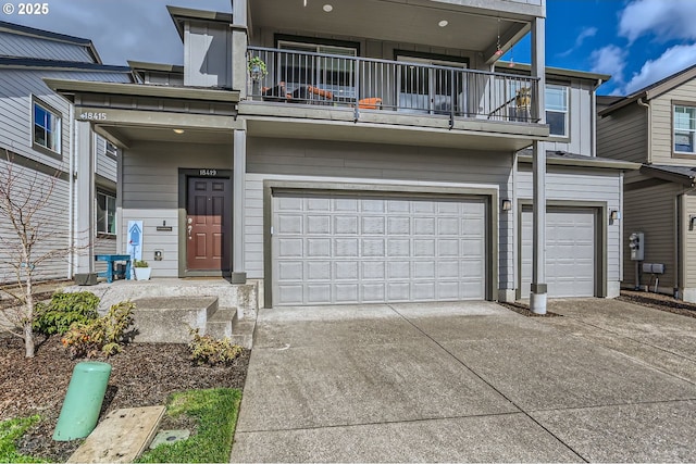 townhome / multi-family property featuring a garage, concrete driveway, and a balcony