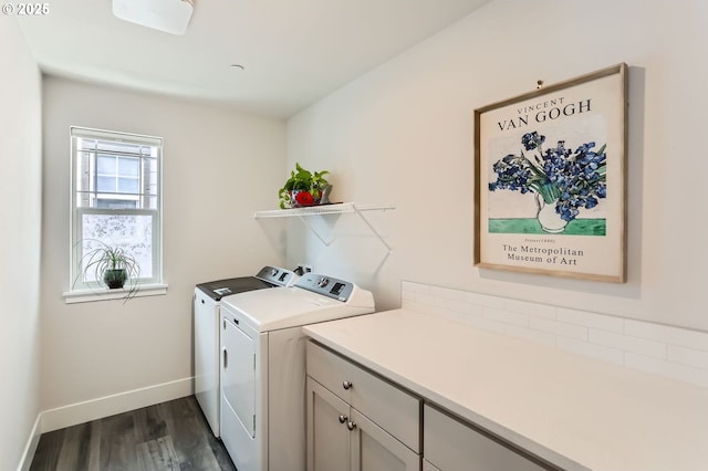 laundry area with cabinet space, baseboards, separate washer and dryer, and dark wood finished floors