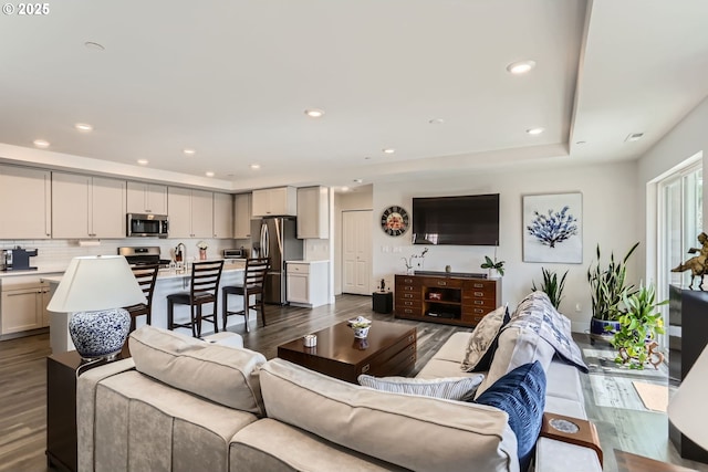 living room featuring dark wood finished floors and recessed lighting